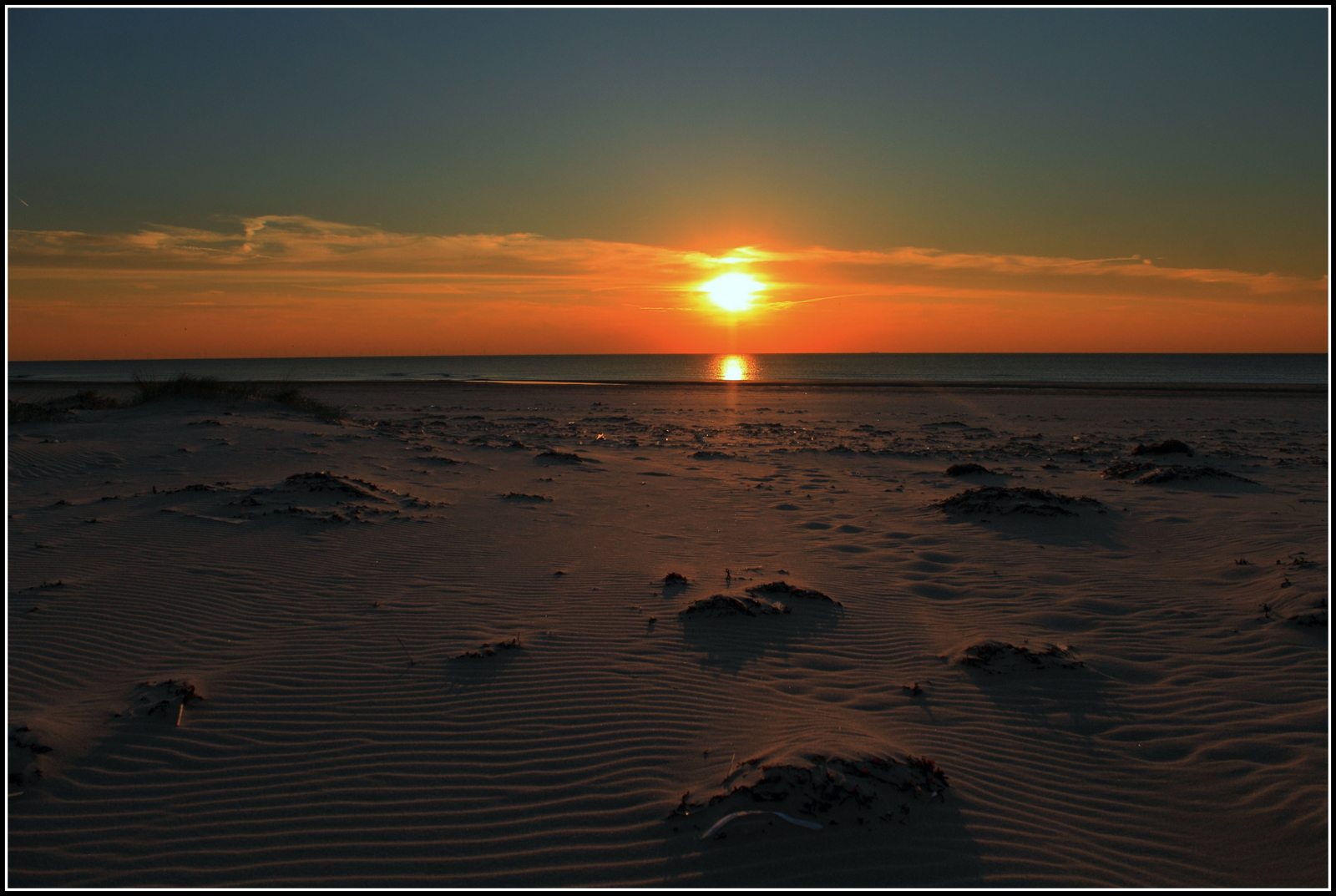 Zonsondergang strand.