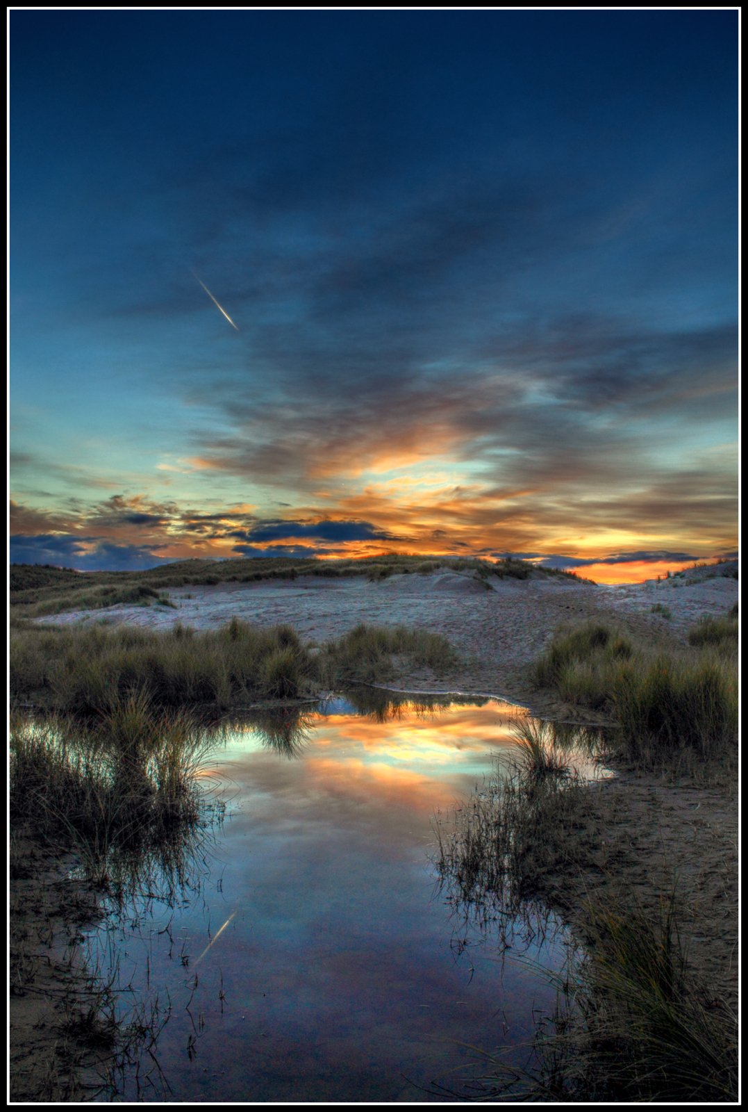 Zonsondergang strand/duinen.