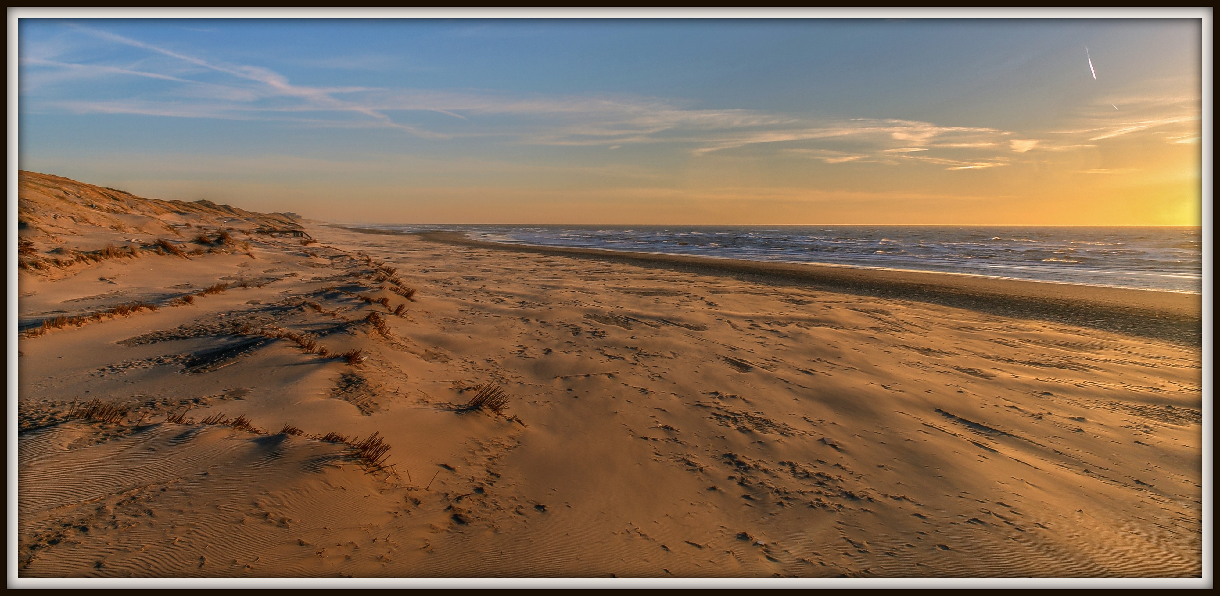 Zonsondergang strand.