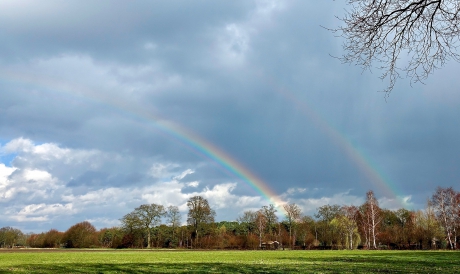 Dubbele regenboog in spiegelbeeld
